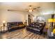 Open living area with two brown leather sofas and wood flooring at 2227 Howard West Ave, Winter Haven, FL 33880