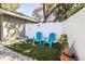 Small patio with two blue chairs and potted plant at 2227 Howard West Ave, Winter Haven, FL 33880