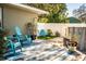 Relaxing patio area with teal chairs and striped rug at 2227 Howard West Ave, Winter Haven, FL 33880