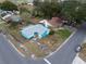 Aerial view of a light blue house with a gray roof and a small yard at 2304 Honey Dr, Lakeland, FL 33801