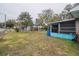 Large backyard with grass, trees, and a partially visible fence at 2304 Honey Dr, Lakeland, FL 33801