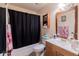 Clean bathroom with a tub, toilet and wooden vanity at 2304 Honey Dr, Lakeland, FL 33801