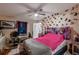 Spacious bedroom with a pink bedspread and butterfly wall art at 2304 Honey Dr, Lakeland, FL 33801