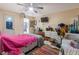 Bright bedroom with a pink bedspread and ample closet space at 2304 Honey Dr, Lakeland, FL 33801