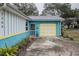 House exterior showcasing a yellow garage and blue siding at 2304 Honey Dr, Lakeland, FL 33801