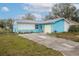 Cute blue house with a yellow garage door and well-maintained lawn at 2304 Honey Dr, Lakeland, FL 33801