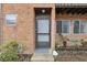 Gray front door with storm door, brick facade at 2369 Tom Jones St # 8, Orlando, FL 32839