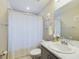 Clean bathroom with shower/tub combo and white vanity at 2610 San Marco Way, Winter Haven, FL 33884