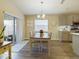 Bright dining area with a view to the back yard and kitchen at 2610 San Marco Way, Winter Haven, FL 33884