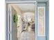 The entryway features a view into the living room, wood floors, and natural light at 2610 San Marco Way, Winter Haven, FL 33884
