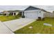 House exterior view, highlighting the driveway and garage at 2610 San Marco Way, Winter Haven, FL 33884