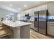 Eat-in kitchen features stainless appliances, gray cabinets, and white countertops at 2610 San Marco Way, Winter Haven, FL 33884
