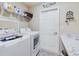 Laundry room with washer, dryer, shelving, and a countertop at 2610 San Marco Way, Winter Haven, FL 33884