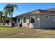 Side view of tan house with screened patio at 265 Laynewade Rd, Polk City, FL 33868