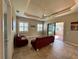 Living room with red couches, tile floors and sliding glass doors at 265 Laynewade Rd, Polk City, FL 33868