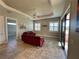 Living room with red couches, tile floors and sliding glass doors at 265 Laynewade Rd, Polk City, FL 33868