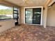 Screened porch with brick pavers and sliding door at 265 Laynewade Rd, Polk City, FL 33868