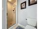 Bathroom featuring a shower stall, toilet and grey tiled flooring at 2720 Ewell Rd, Lakeland, FL 33811