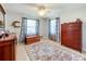 Bedroom with wood dresser and ceiling fan at 2720 Ewell Rd, Lakeland, FL 33811