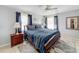 Spacious bedroom with a king-size bed, wood furniture, and large windows at 2720 Ewell Rd, Lakeland, FL 33811