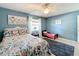 Bedroom with twin and full-size beds, ceiling fan, and large art at 2720 Ewell Rd, Lakeland, FL 33811