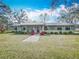 Light blue ranch home with a covered porch and landscaping at 2720 Ewell Rd, Lakeland, FL 33811