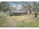 Charming single-story home featuring a classic design, a spacious front lawn and mature trees draped in Spanish moss at 2720 Ewell Rd, Lakeland, FL 33811