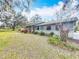 Side view of a ranch home with landscaping at 2720 Ewell Rd, Lakeland, FL 33811