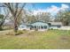 Back view of a ranch home with a patio at 2720 Ewell Rd, Lakeland, FL 33811