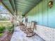 Front porch with rocking chairs overlooking yard at 2720 Ewell Rd, Lakeland, FL 33811