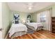 Bedroom with two twin beds, green walls and hardwood floors at 2729 Woodland Hills Ave, Lakeland, FL 33803