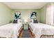 Bedroom with two twin beds, green walls and hardwood floors at 2729 Woodland Hills Ave, Lakeland, FL 33803