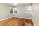 Bright bedroom featuring hardwood floors and multiple windows at 2729 Woodland Hills Ave, Lakeland, FL 33803