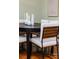 Modern dining room features a dark wood table with white cushioned chairs at 2729 Woodland Hills Ave, Lakeland, FL 33803