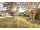 Attractive light green house with sunlit lawn and landscaping at 2729 Woodland Hills Ave, Lakeland, FL 33803