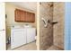 Laundry room with washer, dryer, and shower at 2729 Woodland Hills Ave, Lakeland, FL 33803