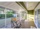 Relaxing screened porch with wooden deck and outdoor seating at 2729 Woodland Hills Ave, Lakeland, FL 33803