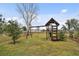 Playset in a grassy backyard with privacy fence at 2774 Verandah Vue Way, Lakeland, FL 33812