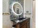 Stylish bathroom with a lit vanity mirror and dark countertop at 2774 Verandah Vue Way, Lakeland, FL 33812