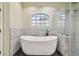 Elegant bathroom with freestanding tub, walk-in shower, and gray stone accents at 2774 Verandah Vue Way, Lakeland, FL 33812