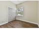 Simple bedroom with wood-look floors, neutral walls, and a double door closet at 2774 Verandah Vue Way, Lakeland, FL 33812