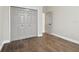 Bright bedroom with wood-look floors and double doors leading to a large closet at 2774 Verandah Vue Way, Lakeland, FL 33812