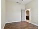 Spacious bedroom with dark brown floors and an additional door at 2774 Verandah Vue Way, Lakeland, FL 33812