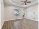 Bedroom with wood-look floors, large window and sliding doors at 2774 Verandah Vue Way, Lakeland, FL 33812