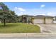 House exterior showcasing a three-car garage and lush green lawn at 2774 Verandah Vue Way, Lakeland, FL 33812