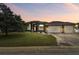 House exterior featuring a three-car garage and well-manicured lawn at 2774 Verandah Vue Way, Lakeland, FL 33812