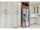 White kitchen cabinets with stainless steel appliances and granite counters at 2774 Verandah Vue Way, Lakeland, FL 33812