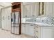 Modern kitchen with stainless steel refrigerator and white cabinets at 2774 Verandah Vue Way, Lakeland, FL 33812