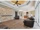 Spacious living room with stone accent wall and hardwood floors at 2774 Verandah Vue Way, Lakeland, FL 33812