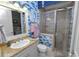 Stylish bathroom with blue floral wallpaper and glass shower at 2961 Sanctuary Cir, Lakeland, FL 33803